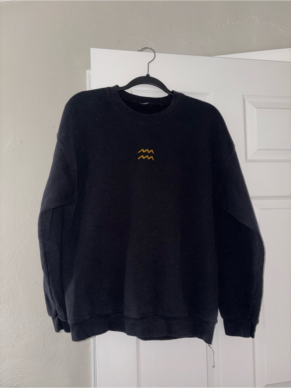 Black Crewneck Sweater with Small Yellow Wave (Aquarius) Embroidery
